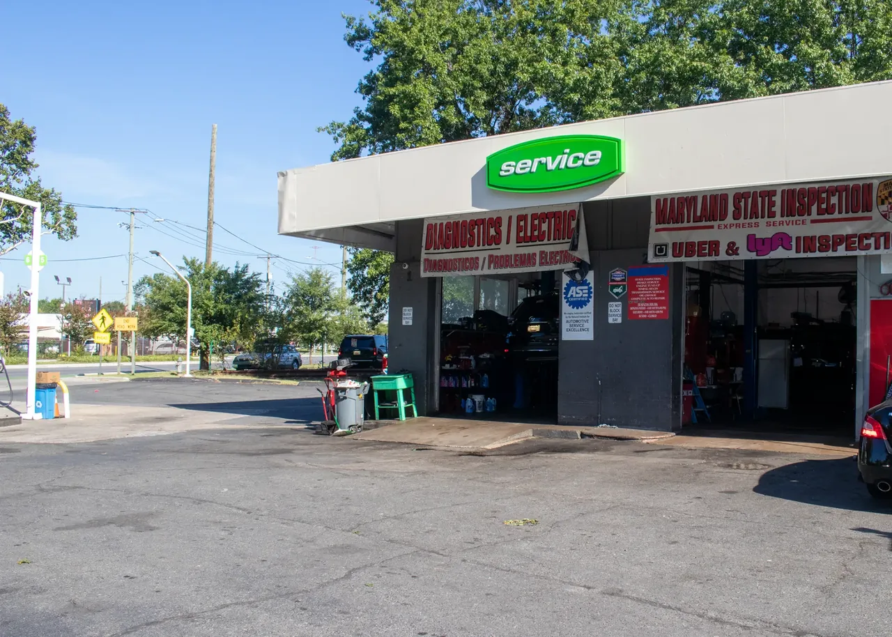 Queens Auto Repair shop exterior with open service bays on Queens Chapel Road in Hyattsville, Maryland